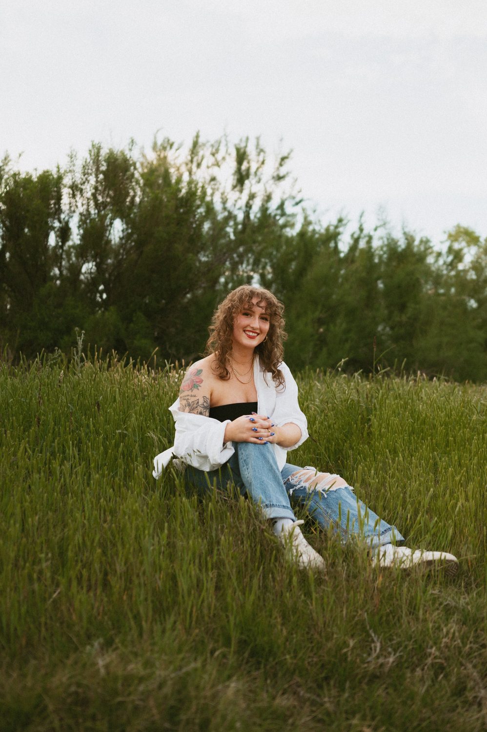 Miami, therapist and founder of Curly Counseling Co., sitting outdoors in West Texas